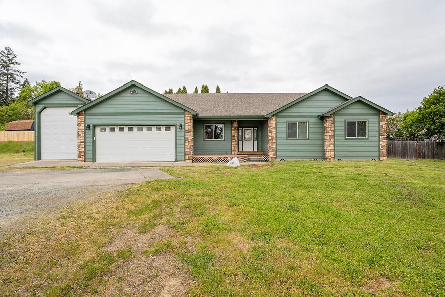 Escape to a relaxing retreat in NW Grants Pass. This stunning 3 bed, 2.5 bath, (plus an office)  single level home is nestled on 1.38 acres close to town with a rural feel! With nearly 1900 sq ft, the open floor plan offers a bright and airy kitchen with alder cabinetry and opens to a covered back patio. The primary suite has a large walk in closet as well as an en suite bathroom with a oversized soaking tub Plenty of room for your toys! Attached garage and 40X16 RV barn with a 12 ft door. Take advantage of the investment potential with this subdividable lot that can accommodate up to 3 additional home sites.