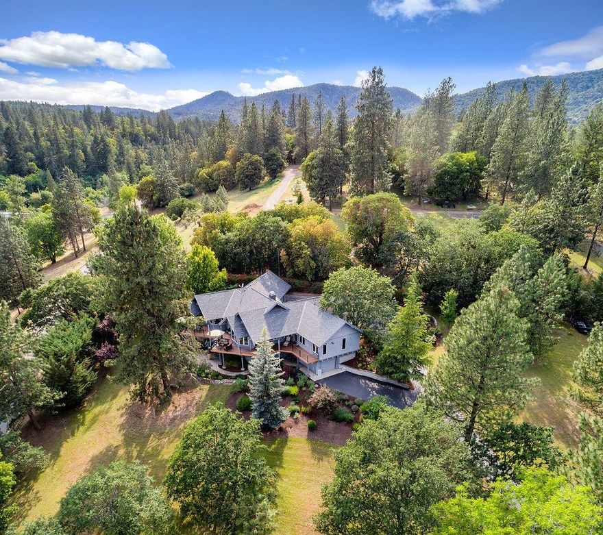 Prime location! Beautiful, well-maintained NW style home feels like a piece of paradise. Located off a cul-d-sac this property includes 2 tax lots for a total of 1.69 acres. The one level-living home overlooks pristine manicured grounds w/beautiful water feature. Greeted by a gorgeous custom carved door, this home incl. lg pozzi windows, 2 decks, lg kitchen w/island, granite counters, stainless appl., sub-zero refrig, 5 burner cooktop, conv. oven, tile flrs & oak cabinets. Lg living rm & fml dining, wood ceilings, wood burning fplc & built-in cabinets. Wood, tile & high-quality carpet throughout. Lg Master w/walk-in closets, 2 designer sinks, heated floors, separate tub, tile shower & floors. 2/12 baths, 3rd bedroom/office. Laundry rm w/sink. 2 water heaters, solar electric system. 3rd garage & lg shop space located on basement level. All new exterior paint, trex decking, paved driveway. 2nd tax lot is buildable - Buyer to do due diligence.