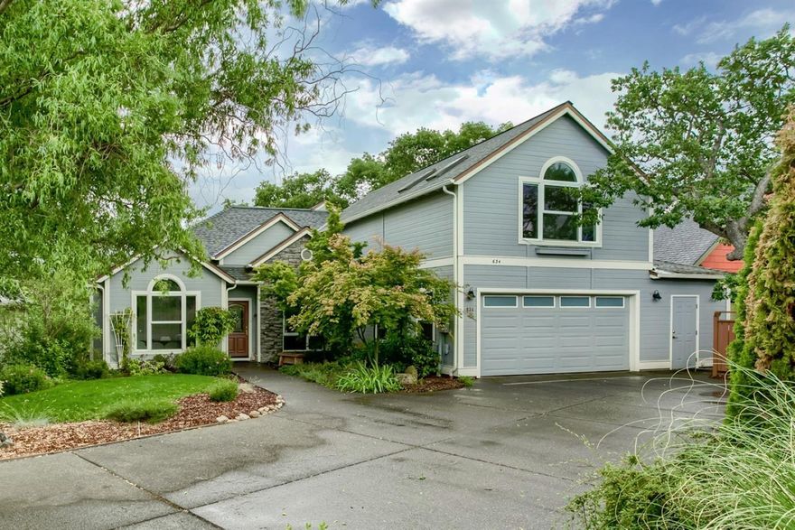 Beautiful Two-story, Contemporary Home in The Oaks in Ashland. Nicely set in a semi-private location, this home features 9 foot ceilings, lovely arched doorways, hardwood floors, nice vaulted living room with gas fireplace, den, formal dining, natural wood cabinets, and tile and granite kitchen with beautiful appointments and lovely views. The spacious master bedroom/bath suite and en-suite guest bedroom/office are on the main level, with two more spacious bedrooms, guest bath and gallery loft area on the upper level. There's a comfortable, private deck at the back of the house to enjoy mature shade trees that open to pretty mountain views, plus a nice garden area ready for cultivation. You'll have plenty of room for your toys in the over-sized double garage with attached shop, extra-large paved parking pad, and great lower level storage area. Driveway large enough for an RV. A nicely maintained and well-loved home!