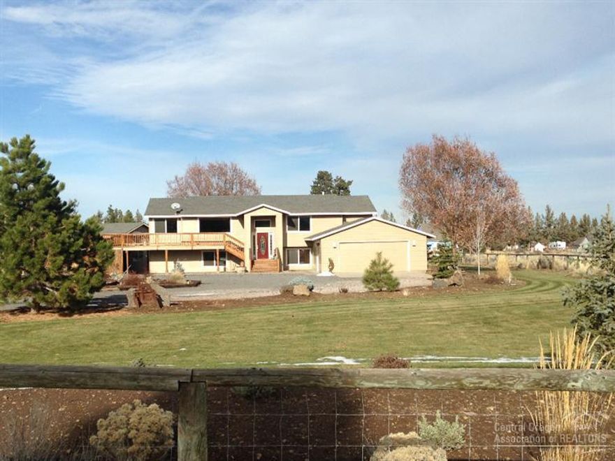 Great location between Bend and Sisters! The outside of this home features a fully fenced park-like setting with a giant yard, speinkler system, fire pit, large deck with a peek-a-boo view of the Three Sisters. This home has been extensively remodeled. Fir hardwood floors, carpet, travertine showers and oversized tub and pellet stove makes this home warm and cozy. And that's not all... 1200sqft insultated shop with concrete floor and double garage doors along with abundance of parking for RV's and Toys!