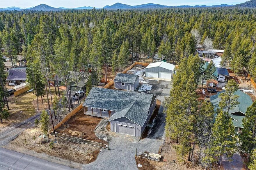 Warning: serious garage envy ahead. This 3-bed, 2-bath single-level home in Oregon Water Wonderland sits on a fully fenced 0.46-acre lot and delivers the ultimate shop-lover's dream. You get an attached 2-car garage, a detached 2-car garage, and a massive 30×40 shop with dual roll-up doors including an extra-tall bay for RVs, boats, and all the toys you swore you'd organize someday. Inside, enjoy vaulted ceilings, a stained beam with hammered brackets, wood-stove with rock surround, and waterproof flooring. The chef's kitchen features granite, a leathered island slab, under-cabinet lighting, and Café appliances including a 6-burner range and double oven. Add RV parking with sewer clean-out and community river access with a members dock. If ''more garage space'' is your love language, welcome home.