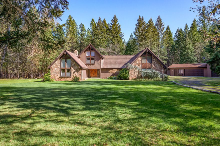 Custom Northwest Chalet on private 10.29 level acres in a park-like setting with 1528 sq foot shop!  Craftsmanship abounds in this 5284 sq ft, 4 bed, 2 1/2 bath home with extensive use of exotic woods & beams. Main floor consists of living room with pellet insert, formal dining room, kitchen with solid surface counter tops, & dbl wall ovens, family room,  lovely master suite with walk-in closet & dual sinks, half bath & laundry room with built-in desk & huge pantry.  Upstairs you will find 3 beds, a full bath, pool/rec room loft with wet bar.  Plenty of closets for storage thru-out.  The shop feat oversize 2 car garage side & an RV bay, along with a covered outside work area/patio on the back.  Other exterior features include 2 garage attached to the home, a few extra sheds, lovely deck with awning for outdoor entertaining & gated entry...all in this peaceful & quiet setting. This is a MUST see!