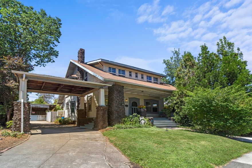 Charm abounds in this turn of the century Craftsman home in West Medford. With 6 bedrooms and 4 bathrooms, there is plenty of space for everyone to enjoy the many original features including 10-foot coffered ceilings, sash windows, tongue and groove ceilings, clawfoot tubs, distinctive brickwork, and an oversized porch perfect for your morning coffee.  Living is easy with the primary bedroom and bath on the main level as well as a second bedroom or office area.  In addition to the home's 2604 square feet of living space, there is a 480 square foot unfinished basement with cold storage.  Outside are a sizable carport and open-air shop/woodworking area attached to a cozy backyard with pavers ready for customizing your outdoor living space!  Interior and exterior entrances to the second story with 4 bedrooms and 2 bathrooms allow for guest or hobby rooms, or potential rental income.  Words cannot do this beautiful home justice.  Make an appointment to see it for yourself!