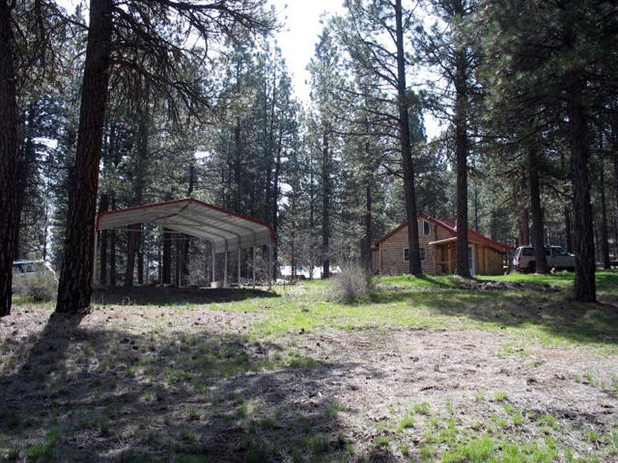 This nicely treed property consists of a cozy log home cabin on approx 9.6 acres. 1 bed/1 bath with a loft area, kitchen Includes propane gas range, dishwasher, refrigerator. Approx 30x36 shop W/3 overhead doors and a finished studio apt. Covered RV carport as well as an additional carport by the home. Property has been surveyed!