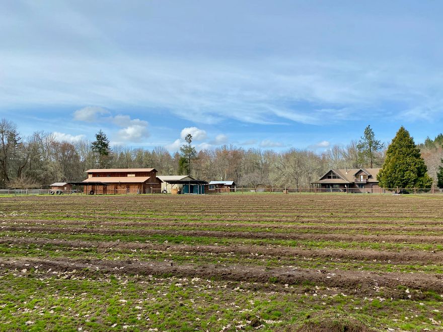 Irrigated farm, move in ready!  Nearly 15 acres of privacy along Little Elder Creek with incredible views, fenced level land, water rights, ponds, security gated entry, and multiple out buildings - ready for your farming needs! The custom timber framed home has views from every window of the surrounding farmland. This quality home has hard wood floors, wood framed windows, large rooms, loft, rec. room, 2 bedrooms and 2 full baths. The barn has 8 large stalls, paddocks, and a large insulated tack room. Studio apartment above the barn, 3 tax lots, huge shop with 5'' concrete slab, and 3 wells. There are currently 2 large cross fenced pastures along with several other fenced garden areas.  Some equipment negotiable outside of escrow.