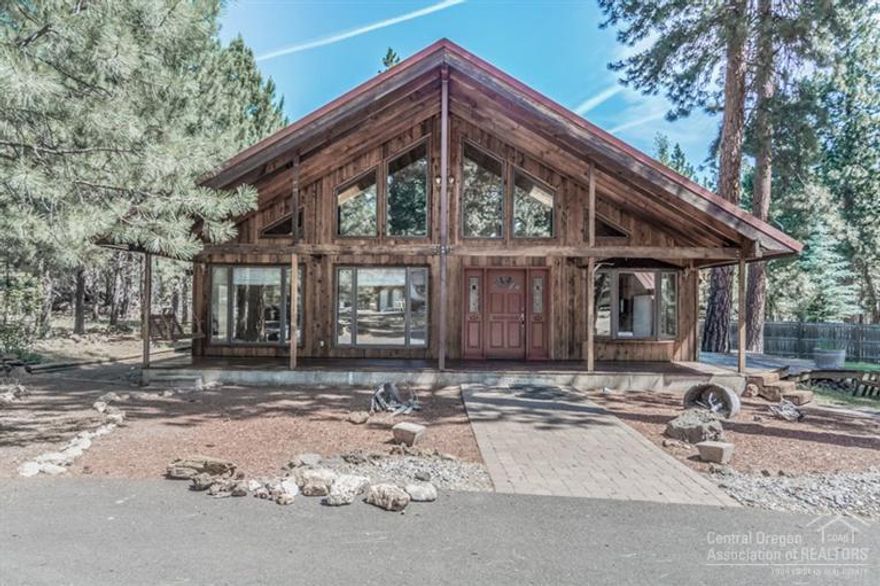 Rustic cabin in the pine trees! Classic chalet in Crossroads featuring vaulted ceilings, recently remodeled kitchen, cozy woodstove and nice outbuilding on over an acre. US National Forest nearby. Don't miss the unfinished room over the carport!