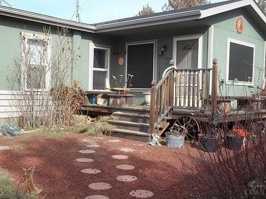 Very well maintained home, ready for new family w/lots of room for pets, RV's & other toys. Home has 2 BD, 2 BA & a den/office that could be used for another bedroom. Nice decks on both front & back of home w/a new wood fence around the yard. Nice established yard w/lots of flowers. There is a 24x24 garage, but only has single door. Very nice frame built building that is a man cave on one end & storage & horse feeder windows on the other & has a great covered front porch. Property is fenced & cross-fenced.