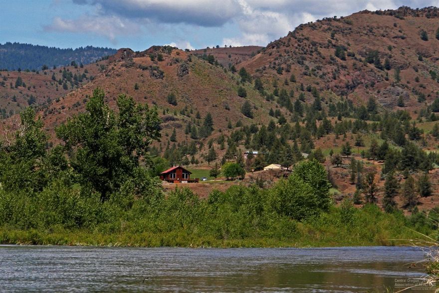 67 Acres On The Wild & Scenic Section Of The John Day River! Private and peaceful Eastern Oregon setting, fun for the entire family, fish, hunt, ATV, swim or just relax, wonderful river and canyon views, gorgeous 2 story cedar sided home, open floor plan, loft & basement, utility room, 3 bedroom, 1.5 bath, pellet stove & heat pump, deck, yard, 27 irrigated acres, pivot, fenced, large shop w/lean to, potential for a meat cooler, hay storage, machine shed. $545,000 #858