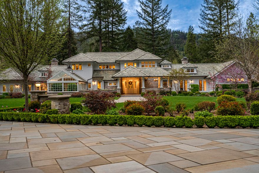 For the first time, this distinguished riverfront estate is made available for purchase. Greeted by a European-inspired bridge & water features, this exquisite English Country estate is elevated above & within the Wild & Scenic section of the Rogue River. Designed by Mike Casella, it blends Arts & Crafts details with Victorian elegance. Highest quality materials & craftsmanship throughout including imported slate roof, hand-carved Carrara marble fireplaces, & custom millwork. A well-appointed chef's kitchen, butler's pantry, root cellar, conservatory, library, main level primary suite with baja & steam showers, dressing room w/ extensive built-ins, and three vanities. Lush and irrigated, year-round color with 1000's of plantings. Numerous water features, 15000 SF garden w/ orchard, berries & vines. Detached gym/home office, finished 3 car garage, barn w/guest quarters, and private riverfront park.