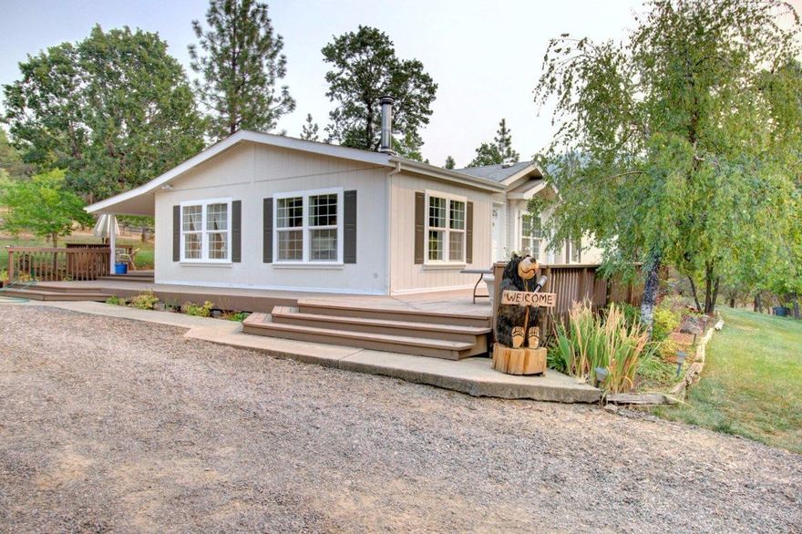 This charming home perfect for horse lovers is situated on a beautiful flat and usable 5.6 acres which is gated for privacy, has a seasonal creek, and backs up to BLM. Enjoy this horse lovers dream, with a 4 stall barn that can be expanded to 6 stalls equipped with power and water. This spacious 1539 sqft home offers 2 bedrooms, 2 baths, a large kitchen, dining room, family room and bonus room area. The large kitchen comes complete with lots of cabinets and counter space, appliances & a breakfast bar. Other features of this home include vaulted ceilings, skylights, a soaking tub, and a certified wood stove to reduce your power bill!. Just a beautiful setting with a seasonal creek, fruit trees, a small greenhouse and raised garden beds. There is ample parking in the 2 car garage, a double carport and a large separate covered RV parking area. Enjoy endless mountain views on the charming front deck or back covered patio. Seller says when they purchased well produced high at 23 gpm.