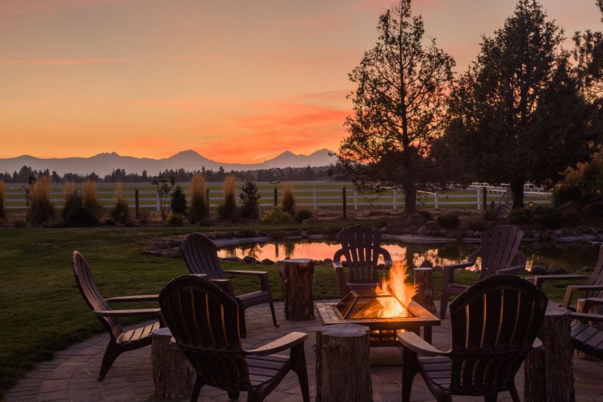 Spectacular unobstructed Cascade Mountain views showcase this spacious single level home. Situated on 3.78 flat acres amid an ultra private park-like reprieve. Property includes water rights maintained with underground irrigation. Tranquil setting boasts a pond, waterfall, paver fire pit patio and lush landscape perfect for children and outdoor entertaining. Enjoy stunning mountain views entering the home, large rooms, KitchenAid appliances, beautiful custom fireplace in large family room are just a few features. Oversized master suite with mountain views. Plenty of space to settle and relax in your luxurious suite with two walk-in closets, soaking tub, large tiled shower, two vanities with sitting area. Large covered patio makes outdoors inviting during the winter. Entire property is fully fenced with dog proof fencing and a private gated entry.  Oversized garage and abundance of space ideal for parking your toys. Rare find with views, room to play and a short walk to Deschutes River.