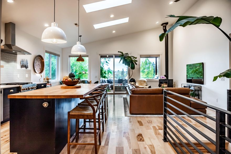 Open Sat. 11/5, from 1-3pm. Newly constructed in 2020; this dwntwn, 2-lvl, 3 bdrm + office, 3.5 bath, custom treehouse-style home, set on a serene, dead-end st., enjoys both the sounds of the Deschutes River & dynamic green outlooks from every window. Flooded w/ perfect natural light & refined by a designers touch, the soaring ceilings of its dramatic lvng space gives way to an artfully designed covered deck that functions as a 2nd lvng room - views S. include Tower Theater, Old Mill Smokestacks & Newberry Monument. The homes reverse lvng floor plan offers huge flexibility. For a single lvl option, enter the home via the alley w/ a 2 car SxS grg + strg. You'll find the primary ste, w/ spacious closet & deep soaking tub, an incredible kitchen that is highlighted by a massive island; natural & striking, large laundry room, 1/2 bath & pantry + a living/dining space w/ a wd brn stove opening to the most fabulous deck that spans the front of the entire home. Scroll photos for more detail