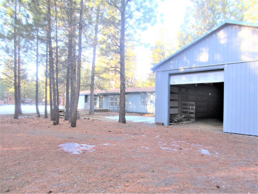 Welcome to Crossroads  - A Sisters Oregon community just a few minutes outside of town. Surrounded by Deschutes National Forest and just a short 10 minutes to the high school. . Manufactured home on  .98 acres. Plenty of parking for all your vehicles and toys. There's also a 1536 sq. foot metal shop with dirt floor. Lot's of potential with some sweat equity. Newer Alternative Treatment Tech System. Short term rentals allowed. On a private well.