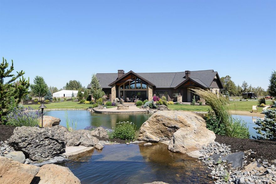 Exquisite custom home, Cascade Mountain views & Tumalo acreage just minutes from downtown Bend: simply ideal. Impressive great room with grand moss rock fireplace & custom beam detail leads to large paver patios & filtered swimming pond with beach entry. Chef's dream kitchen features high end Thermador appliances; stone arch over range; granite counters & huge pantry. Tranquil master plus 2 suites & office on main; bonus & 4th suite upstairs. Approved plans for shop/guest suite are available.