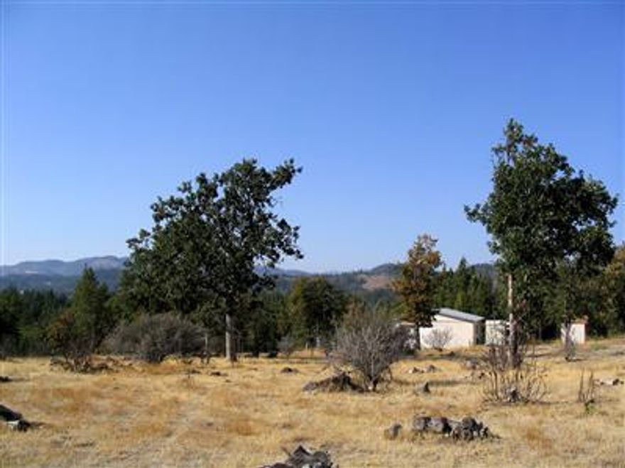 Spectacular views from this 2 1/2 acre level parcel. Peaceful country setting between Eagle Point and Butte Falls. 1981 built mobile home is livable but value is in the land. Detached garage/shops, barn, and outbuildings.