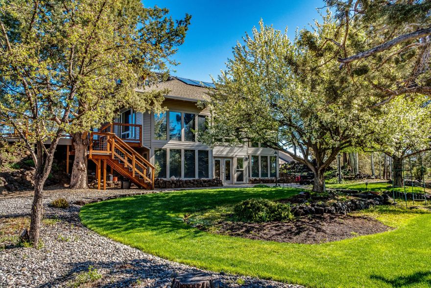 Private living at its best! This truly unique property is located on a dead-end street, in one of Bend's best-kept secrets, Stoneridge. The lovely home is 3740 sq. ft. with a 3-car garage, large shop, RV parking, office, guest quarters, and amazing greenhouse. The primary suite is on the main level,
and the great room has an open floor plan, vaulted ceiling, skylights, and floor-to-ceiling windows which allow natural light throughout. Energy costs are extremely low with the Trombe Wall passive solar heat and cooling. The kitchen is equipped with energy-star certified stainless-steel appliances, solid granite countertops, and alder cabinets that are complemented by the hardwood floors giving the home a warm and inviting feel. A perfect home to entertain, and watch the sunset with panoramic cascade mountain views. Tons of storage and room for all your toys. This secluded property is nestled around expansive lava rock outcroppings which make it the perfect private oasis.