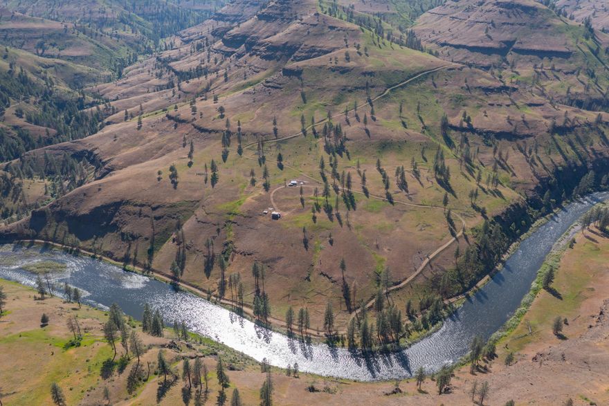 This spectacular recreational property spans over 1.5 miles of both sides of the Wild & Scenic North Fork John Day River and is surrounded by BLM land. Enjoy exclusive access, starting at your gate, ensuring ultimate privacy for hunting, fishing, rafting or just relaxing on this expansive property. Wildlife thrives year-round, including trophy big game. Plus, get two valuable LOP tags! The newly constructed cabin has panoramic views of the river and the deep dramatic canyon it has carved over the millennium. You'll enjoy ultimate privacy here, as the public road ends right at your gate. This specific part of the North Fork is famous for its highly sought-after, permit-only river rafting during a short season, offering a unique adventure for whitewater lovers.  When the CFS is too low for rafting, you can drop off your UTV miles downstream and come back to float the river in complete privacy on your paddle board or kayak. The bass, trout and salmon fishing in the summer is epic!