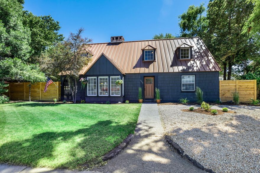 Step back in time while enjoying modern-day comforts with this home thought to be built by the US Forest Service in 1938. This property exudes quality construction and classic craftsmanship, featuring an iconic stone fireplace and an enduring copper metal roof. Original hardwood floors and multiple built-ins add to the home's authentic charm. The home offers a full basement with tons of storage that has been fully updated. Recent updates include new exterior paint, new cedar fence in the front yard, and newly landscaped rock and bark in both the front and back yards, updated light fixtures and vinyl flooring in kitchen and bathroom. The back garage has been renovated for parking and storage for tools and toys. Enjoy the convenience of walking distance to schools and downtown, along with ample RV and vehicle parking accessible from the alley. This property is full of character could also serve as a potential commercial space. Your dream home or investment waits for your vision!