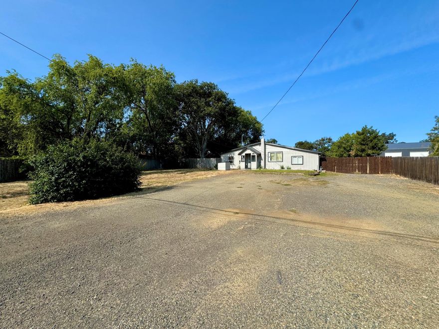 Looking for space for all your animals, gardening and toys, yet still want to be close to everything? Look no further than this 3 bedroom 1 bath home on a huge oversized .66 acre lot in Central Point. This property boasts fresh and modern exterior paint, a nice covered deck in the back, large mature trees, a horseshoe pit, wide open spaces with a large barn-like workshop/ shed for added storage. Inside, you'll find updated finishes, including dual pane vinyl windows, charming touches like arched doorways and ceiling accents, an updated kitchen and bathroom, stainless steel appliances, a large laundry room that can double as pantry storage and so much more. This property has more potential than most properties that you will find in this price range...the possibilities are endless! Truly a must tour!