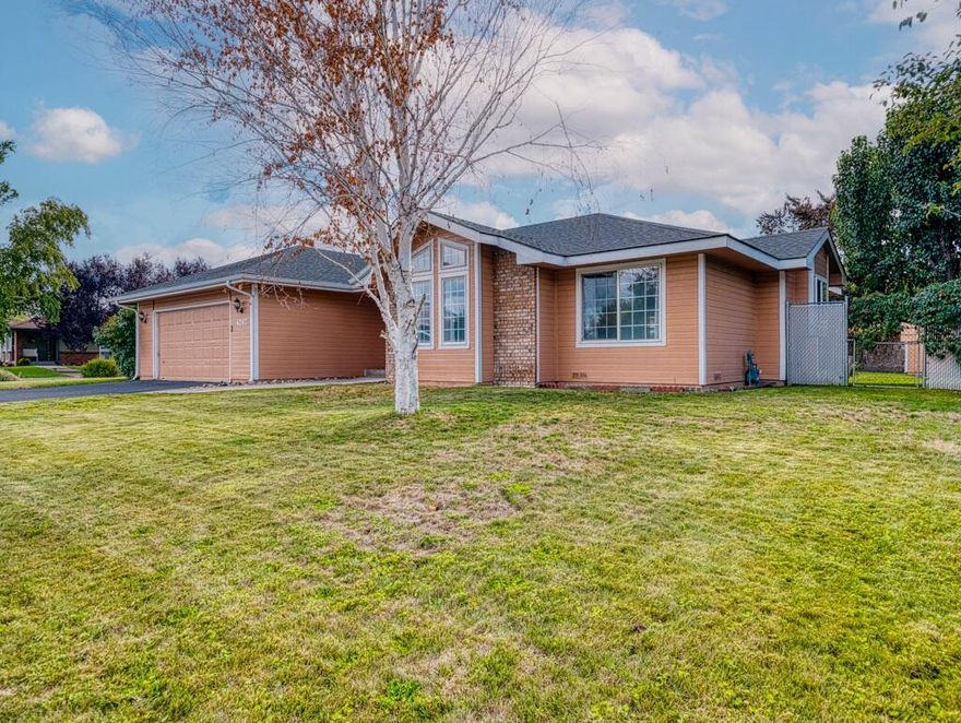 This 3 bedroom, 2 bathroom home sits on a large corner lot in the charming Sunset Village neighborhood. It features a bright and spacious living room, a cozy dining area, an elegant kitchen with stainless appliances, a pantry, and bar seating. The dining room has a sliding door leading to the backyard where you can enjoy fresh air, picturesque landscaping and mature fruit trees. The primary bedroom hosts a walk-in closet and ensuite bathroom and is located furthest from the living area to enjoy peaceful solitude. This home also offers a laundry room, 2 car garage, in-ground sprinklers, a fully landscaped yard, storage shed, rv hookups, and 2 driveways for plenty of parking. Don't miss this amazing opportunity to land your forever home. Schedule your private showing today!