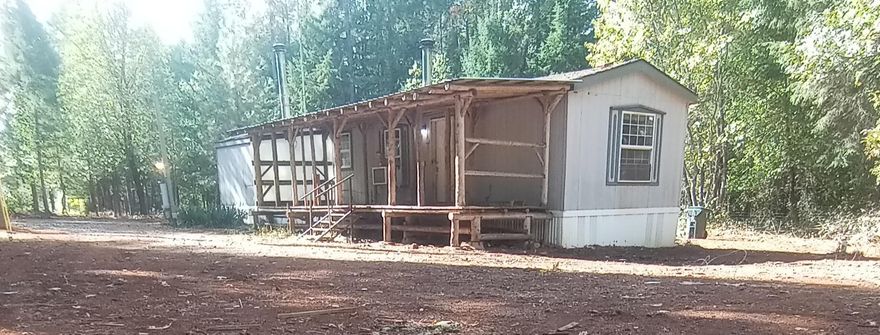 Five private acres. This property includes a habitable 1995 single wide manufactured home, a 2.6 gallon per minute well, a standard septic system. The property has mature pear and apple trees. The property is fully fenced, gated, and level.