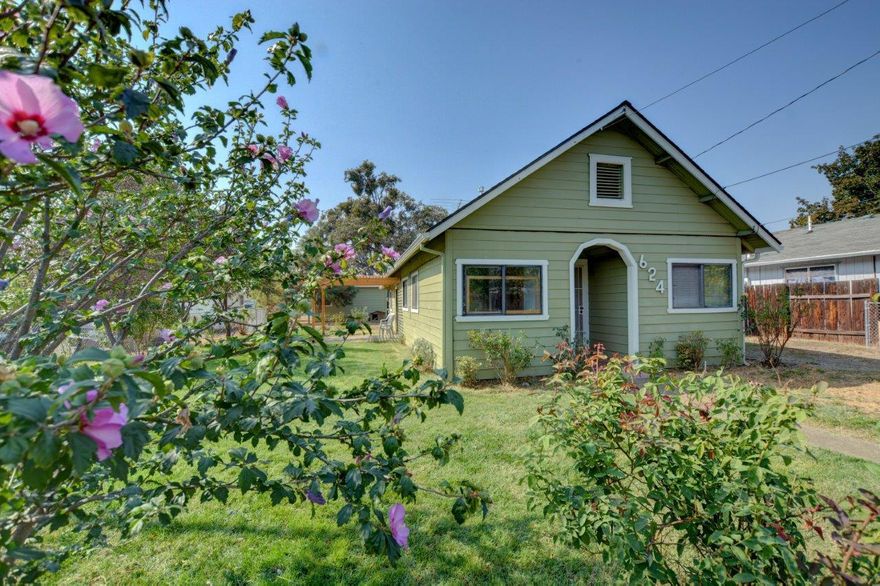 Arched covered porch entryway, lots of parking with two separate driveways, office nook, tile, sliding patio door, double paned windows, large out building, large fenced yard.  And it's affordable.  Hurry to see this one!  Perfect for a first time home buyer!  A corner lot tucked into a quaint West Medford neighborhood.