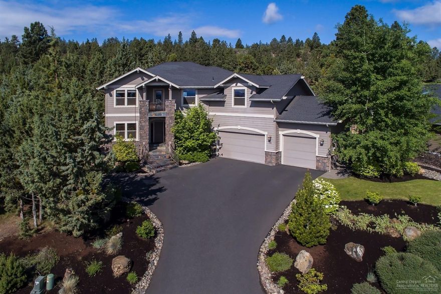 Stunning home on the 17th fairway of River's Edge Village Golf Course. Spacious open great room with floor-to-ceiling stacked stone gas FP w/built-ins, hickory hardwoods on lower level & stairs. Gourmet kitchen boasts stainless steel appliances, granite counters & large island. Wonderful master w/gas FP, privacy balcony w/views to the east. Upstairs bonus room w/bar including fridge/icemaker. Oversized 3 car garage. Fabulous backyard w/patio that has built-in BBQ, gas fire pit & hot tub for entertaining!