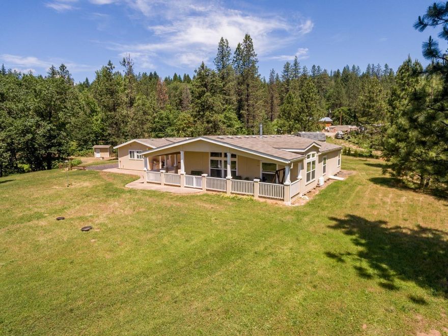 Experience a private and peaceful 2.7 acres of the beautiful Rogue Valley. This single level wheelchair accessible home comes with many additional features. There is a 16x9 shop that includes an 8x5 built-in vault, a 20 x 30 office wit bath, and over-sized & extended length, finished 3 car garage. These are in addition to the 1863 sq ft living space, all under one roof. The open floor plan includes a panoramic view of the country side, vaulted ceilings, gas fireplace, dining area, and a kitchen with walk-in pantry and island work/seating area. The master suite has 2 walk-in closets, and large master bath. The second full bath is spacious with over-sized tub/shower. The exterior includes a covered front deck which runs the entire width of the home, stamped concrete walk-way, fenced garden area, small vineyard, fruit trees, and a 198 sq ft barn/storage building with loft. Extensive additional parking areas. All this and only .2 miles from the famous fishing hole and boat launc