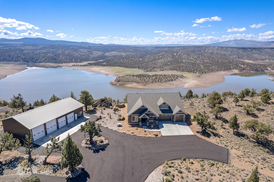 THESE PHOTOS do NOT REFLECT the DRAMATIC ELEVATED BLUFF & POSTCARD VIEWS!  Situated in a premier gated community overlooking the Prineville Reservoir just 15 minutes south of town. Pass through your own private driveway gate onto your 4.77 acres, up the paved serpentine driveway through the trees to arrive at your lake view estate. Step into the custom built home & see the splendor of the lake views, canyons, rocks and buttes. Abundant wildlife will keep you company year round & the immense peace & serenity of this setting will relax you. The home is exquisite with upgraded lighting, flooring, cabinetry & design features all on one level. The 4 bay, 40x66 shop with game room means all your toys and projects are protected. The trees are limbed up & there are ample fire breaks around the structures. This is a premium, unique lot with unmatched views. Where could you duplicate this setting? Imagine waking up to these views, this luxury, the serenity & quiet you deserve... wow!