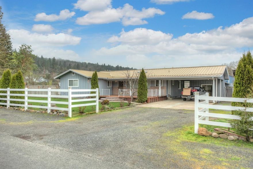 Beautiful well loved 3Bd/2Bth home with a huge covered deck of approx 612 SqFt to enjoy the outdoors and views of a nearby mountain range. Feels like country yet very close to town. The home also has an 8 seater Hot Tub to relax in and enjoy the sunsets. Newly renovated large kitchen with all new appliances in both main house and and a potential income generating 1BD/1Bth detached cottage. Double carport and RV Parking. The home is located in a quite, private location. This carefully tended property also boasts fruit bearing trees and a level yard partially fenced making this your perfect buy. Close to South Medford High School.