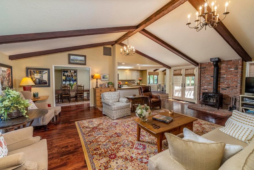 Step into luxury in this beautiful home  surrounded by the privacy of 2.71 treed acres in the desirable Woodside Ranch neighborhood. This custom home offers 3474 sqft of living space on a single level. The foyer opens to a beautiful entertaining space w/vaulted ceilings, lots of light, wood burning stove. In the kitchen, enjoy Bosch SS appliances, Jenn-Aire cooktop/oven & custom cabinets. Dining area overlooks the back yard w/access to patio deck. Primary suite offers an open vaulted room to enjoy the sitting area with French Doors leading to patio deck, perfect for your hot tub! The 2nd primary suite is bright & light w/access to side deck. Attached Apartment w/LR, Kitchen, Bedroom, Bath w/private entry is a BONUS! Beautiful landscaped yard w/water feature, front/back sprinkler system, paver walk ways, retainer walls & gated RV parking, raised garden beds & much more. Fenced & 2 automatic gates for security. See Home Improvement List for more info. Come see & enjoy the BEST of BEND!