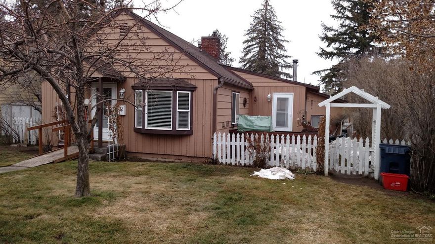 Absolutely adorable English MID-TOWN find! Charm. Laminate wood style floors, nice moldings and built ins. Outstanding remodeled large kitchen w/priv patio w/planters for fresh herbs. Picket fence. 672 Sq Ft finished shop and o.s.double garage, alley access and RV parking. Newer vinyl windows, FAGas heat, gas stove, THIS is a rare MID TOWN. One owner last 27 years. Well loved home.