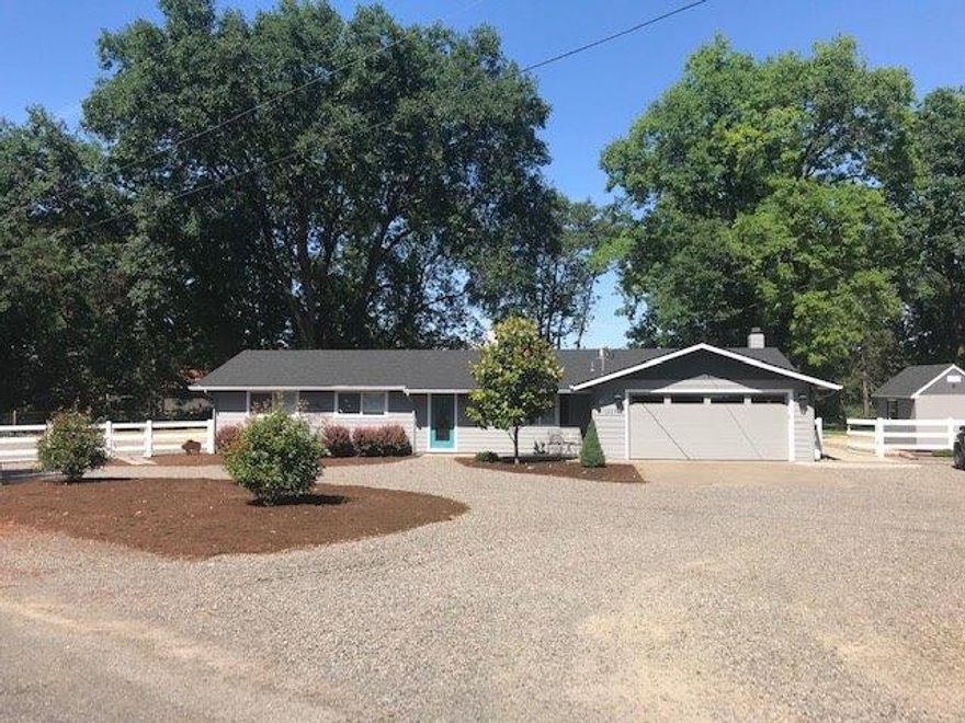 Medford charmer with LAND and Creek Frontage! This charming Medford ranch style home sits on an acre of land, offering all single level living in the 1,504 sqft with 3 bedrooms and 2 full baths. Open floor plan with wood floors in entry, living room, dining room and kitchen. Home has numerous upgrades inside and out, including new stove top, gas fireplace insert, water heater, blinds, shed, carpet, roof, bathroom remodel, exterior painting and much more. Large front yard parking for guests, RV parking or Toy storage. Enjoy views of the beautiful landscaping, local valley and mountains from inside the home or step out your back door and enjoy this huge back yard with lawn, patio, fire pit area and utility shed. Live the Southern Oregon Experience! A Must See.