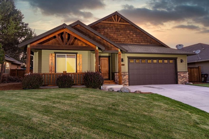 Craftsman home with Country Lodge feel on large lot in Redmond. Open concept in living room, kitchen and dining room with access to very nice fenced backyard with pergola covered patio. This 1650 sq.ft. home built in 2007 features 3 bedrooms, 2 baths, vaulted ceilings, gas fireplace with floor to ceiling stone surround, hickory floors, plant shelves and wood framed windows. Spacious kitchen features island with eating bar, pantry, ample counter space, gas range with electric oven, new dishwasher and granite counters with tile backsplash. Double attached garage, underground sprinklers front and back with drip system. Small area for extra parking on north side of home. No HOA's. Great for outdoor entertaining!