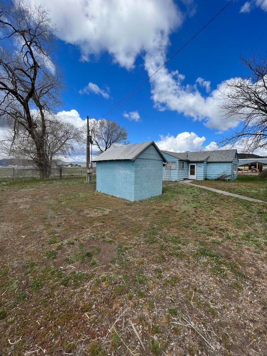 2.85 acres near Malin with a large 2000 SF shop and 4 car garage/machine shed (550 SF).  Shop is built on a concrete slab with water & electricity (including 3 phase power), roll up doors and walk thru doors.   There is an old, buried cellar and large 60 x 120 cellar (potato cellar, now used for storage) are also on the property.   There is a 1560 SF Machine Shop as well.  Ranch style home is 3-bedroom 2 bath that needs TLC.  Property is sold AS IS.  Buyer to do own Due Diligence and pay for any inspections.