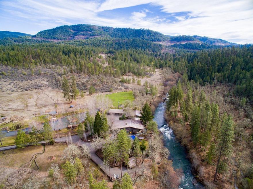 Spectacular 40 acre ranch with magnificent home perched above Big Butte Creek may be what you've always dreamed of & more! Seclusion, Woods & Waterfront. Located about 30 min. from Medford's major conveniences & international airport. Surrounded by a vast tract of private BLM land it abounds with wildlife. Stunning landscape surrounds the home & large stocked pond with decks, docks, canoe house & island. Split rail fencing & rocked pathways lead you to a sleeping cabin on the creek. 4673 Sqft custom home is incredibly stunning with large pane windows & stonework overlooking the creek. Superb workmanship & architectural design abound in the home. The grandeur of the outside becomes part of the inside. The 1660+- Sqft master suite with stone fireplace has 2 elegant bathrooms, 4 person sauna. The main part of the home features awesome Kitchen and 2 additional suites. 5 tax lots with additional buildable. See attachments that describe this chic hideaway in detail. Virtual tour & video soon