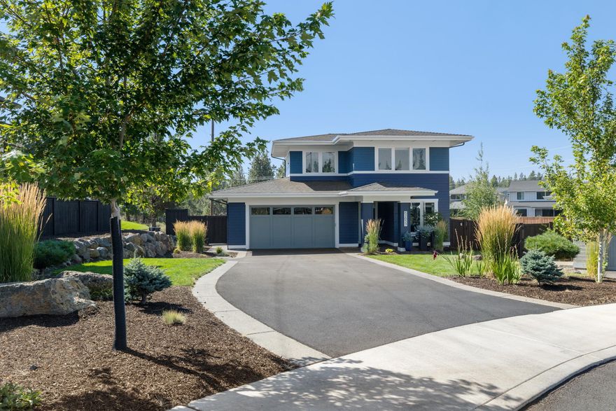 The cool, contemporary lines of this immaculate prairie style home are timelessly classic. Refreshing interiors include a spacious great room that flows seamlessly into the spacious, chef friendly kitchen with a Filli Bertazzonia Italia 6-burner oven, breakfast bar/island, pantry and cheerful dining area that opens to back patio and large, fully fenced & landscaped back yard.  Main level is home to the peaceful primary suite with barn door separation from bath with dual sinks, water closet, tiled shower & walk-in closet, as well as a bright front office overlooking the lovely front landscape. Wood & tile flooring throughout main level. The upstairs retreat incorporates two generously sized guest rooms and an oversized bonus room that provides plenty of space for a multitude of uses.  Located at the end of the cul-de-sac of other equally beautiful residences & only minutes from the 981-acre Shevlin Park and Tumalo Creek, offering miles & miles of walking paths and mountain bike trails.