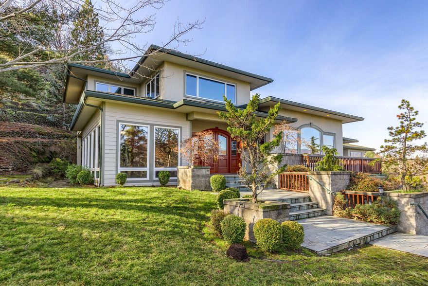 Beautiful In-Town Estate on a Private ¾ Acre Lot with Sprawling Ashland Views! This 1995 John Fields home is the definition of Grand--majestic entry with cherry staircase, huge slate Solarium, expansive great room, 12-foot coved ceilings, gorgeous custom woodwork, fireplace, wide-plank maple flooring and oversized windows throughout. Beautiful formal dining, spacious kitchen with extensive cabinetry and solid-surface counters, subzero fridge, double ovens, gas cook top and big pantry. The generous owners' suite includes double walk-ins, oversized bath, hand-painted basins, privacy commode, shower and soaking tub. An oversized office/bedroom features nine-foot ceilings and cherry built-ins. Two spacious upper-level guest bedrooms share a custom tile bath.  The triple garage with shop connects to a studio apartment with private bath. All this and lovely tiered landscaping, patios, decks, gazebo, stacked rock walls, mature specimen trees, ground covers, and gorgeous flowering shrubs. Wow!