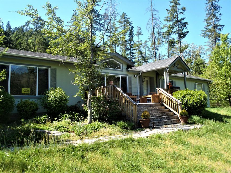 This is your chance to own the Oregon Dream!!!
If quiet and peaceful are what your looking for this is it!!! Beautiful well cared for manufactured home in a private setting surrounded by trees, but with wide open space around home for an open feel and fire safety. This home looks like a quality stick built custom home. Front deck looks across the valley and the flagstone rear patio is right for relaxing. Fenced around the house so the deer won't eat your plants! This place is set up for your comfort and relaxation. Huge water holding tank in storage shed provides gravity flow pressure and capacity for safety. Last well flow test came in at 9.5 gal at start and ended at .3. New stainless steel sink, new electric range,, new microwave.