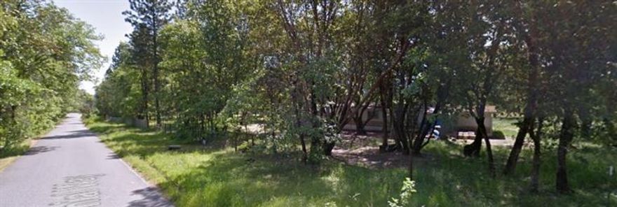 Bring you dreams, grab your builder and your plans to build your own custom home here on this 1 acre level, treed and private lot. The MH holds the homesite approval in place. The seller says the septic was just serviced within the past year and that it has a good, strong well! So what are you waiting for! Owner is highly motivated to sell NOW! Please do a drive by and do not disturb the tenant.