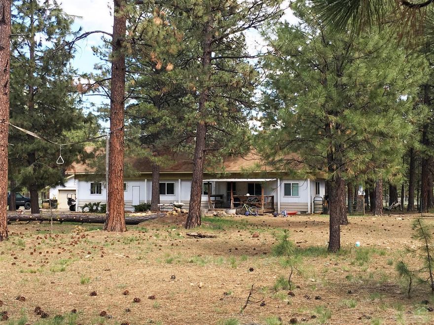 Live comfortably amongst the Ponderosa Pines on this beautiful, totally usable 1.12 acre parcel backed up to U.S. Forest Service land. Manufactured home could be used as a rental or permanent residence. New vinyl windows, septic, and laminate wood floors throughout.