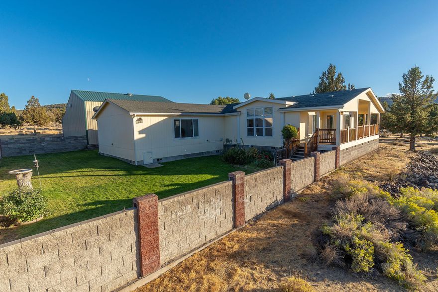 Country Living close to town on 2.3 ac. positioned to enjoy Cascade Mt & Valley Views. Lovely well- kept home built in 2001 w/ 1860 Sq Ft SHOP, heated & large enough for RVs & toys plus enclosed storage room above & adtl 3rd bay. Triple wide Good Sense MFG Home, 2872 Sq Ft, 3 bedrooms, 2 baths, vaulted 10' ceilings living rm & family rm w/tray ceiling, plus large bonus/flex room could be another bedroom, studio, office or in-law suite, w/separate entrance. Spacious open efficient kitchen, sm island, eating bar, pantry, great counter space & plenty of cabinets. Open dining room positioned with living room on one side and family room on other side, offers lots of natural light w/access to large, covered deck or access the cozy backyard. Nicely landscaped, minimal upkeep w/ concrete block fenced back yard, paved driveway & private end of street setting. Great location facing the Setting Sun!