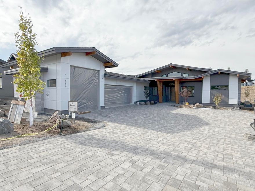 Far from your typical spec home, this single-level residence offers custom-caliber finishes in a stunning setting. A modern mid-century aesthetic is elevated by premium siding panels, an XL paver driveway, and extensive beam work front and back. The distinction continues inside with 24x24'' Italian tile in all bathrooms, floating cabinets, backlit mirrors, and dropped showers with infinite drains. The great room offers indoor/outdoor living through three-panel sliding doors that open to a patio with hot tub prep and screening, all backing to 15+ acres of green space and trails. In addition to a catalog-worthy primary suite, the home includes two additional en-suite bedrooms, a dedicated office, and a fourth bedroom that can serve as a den, gym, or media room. Need space for gear? You'll appreciate the oversized three-car garage with Sprinter bay. With completion expected before Thanksgiving, now is the time to secure custom design, premium finishes, and exceptional Westside access.