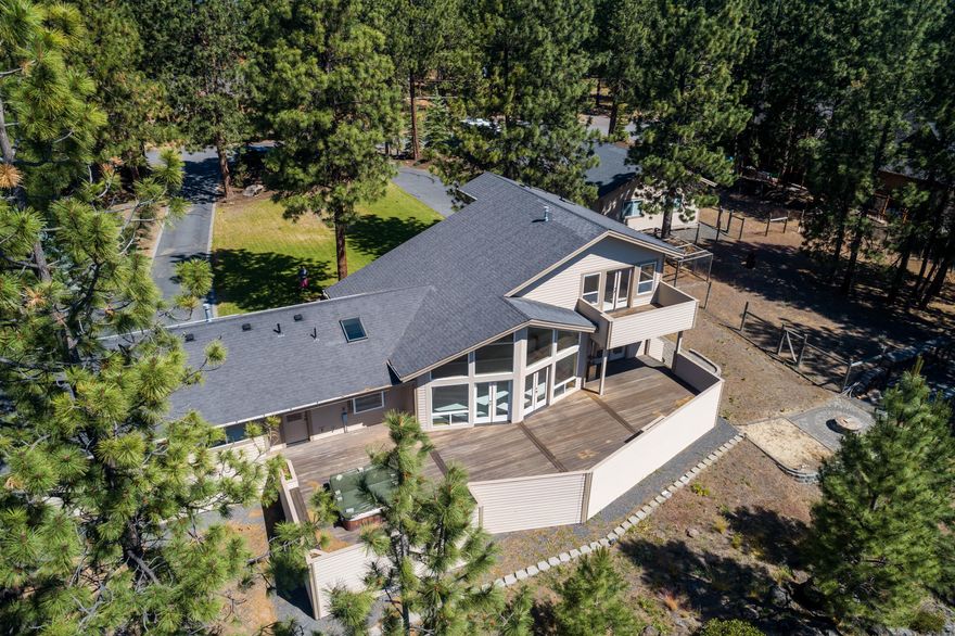 Situated high on the Rimrock above Century Dr on the way to Mt. Bachelor, this private setting offers mature pines & landcape on nearly an acre of prime west Bend property. A true custom home, this unique floor plan features a prow front wall of windows to capture spectacular views of the tree tops. Open living space w/soaring 2 story vaulted ceiling, natural wood trim & accents throughout. Spacious Master Ste has a private deck & oversized bath. Expansive deck off the Great Room makes entertaining a lg party comfortable! Attached dbl car garage 
 paved drive. You'll enjoy the heated 1,800 shop year round - with space to store all of your toys & have a work space too w/tons of built in cabinetry. Vaulted ceiling in part of the shop for taller RV access. Just minutes from downtown Bend, Phil's Trail, Alpine Park & Tetherow. Live & play here - or subdivide w/potential to create 4 individual home sites. Don't miss this one!