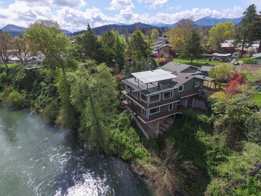 You knew you were coming to see a River Front home and you've seen the amazing photography for the listing...but nothing prepares you for what you see. You walk through the front doors and the Rogue River stretches out before you for miles. Your home is positioned perfectly to give you 180 degrees of shear beauty. The fire place in the center of the living room flickers as you pinch yourself to make sure you haven't strayed into a dream. The spiral stair case takes you to the roof top deck and the views just continue. Below your home is spacious and ready for your touches. The kitchen has been tastefully remodeled and right off the living room so you can enjoy the river from the kitchen sink. The owner will carry the financing for the right buyer, but the competition is fierce for homes like this, so don't delay.