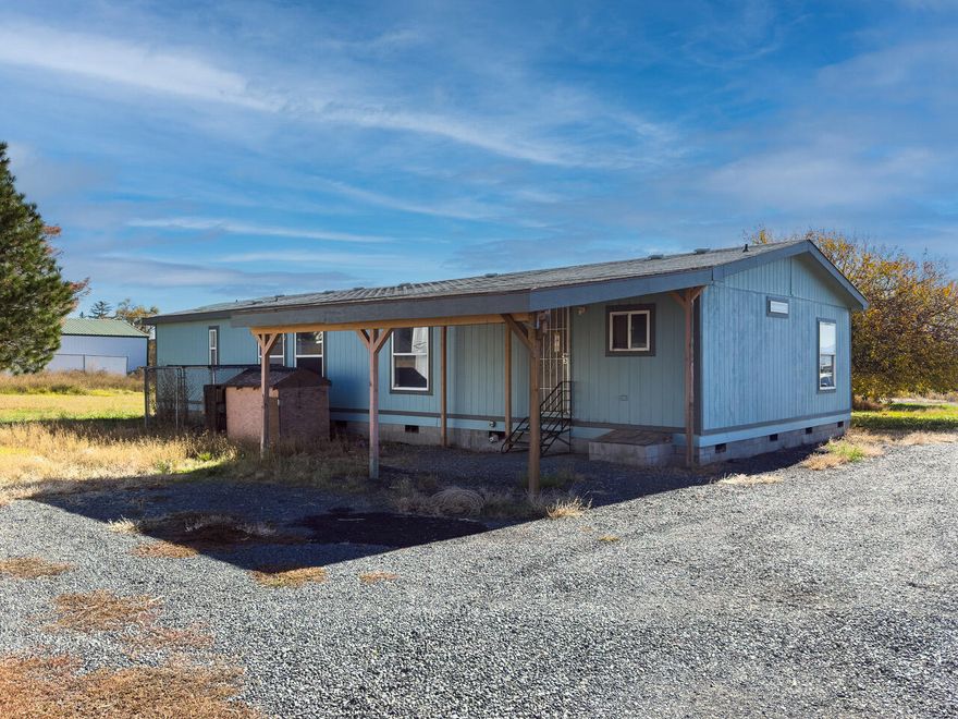 Small Acreage! Here is your chance to have just over an acre right here close to the heart of Klamath Falls! Enjoy this open floor plan featuring Spacious Living and Dining Area, Vaulted Ceilings and a Kitchen that includes a Kitchen Island with plenty of cabinet space as well as a Pantry! Large Laundry room with plenty of storage, The primary Suite has an attached bath. The large front covered deck is perfect for enjoying those beautiful sunsets or would be great for a Summer BBQ! This property also includes a large Quonset shop with plenty of space for your RV's. This is also a great opportunity to have 4-H animals! You will love the feeling of country living.
