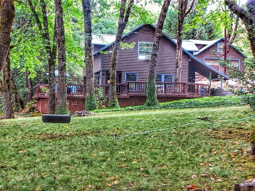 Two Family Setup ~ on the Rogue River!! This 2 family setup on the Rogue River is a must see. This Rogue River frontage wooded wonderland includes nearly 3 acres, a 1500 sq/ft main house (2bed/2bth), a 621 sq.ft. guest home (1bed/1bth), and a 1300 sq.ft. shop. The rural setting provides for very comfortable living. The main home features spacious kitchen w/ hardwood floors, living room, large master w/ full bath, gas appliances, open beams, and a gorgeous original fireplace (gas insert). All surrounded by a 900 sq.ft redwood deck. The guest house would make a great mother-in-law suite, vacation rental, or care-takers home. The 1300 sq.ft. shop (w/professional office) has room for all the toys. The grounds feature large mature oak and maple trees with a large circular drive. The Rogue River waterfront (across RR Hwy) needs some improving to reach it's full potential, but boast some of the best fishing around! This would make a great vacation or family resort. Don't miss this opportunity