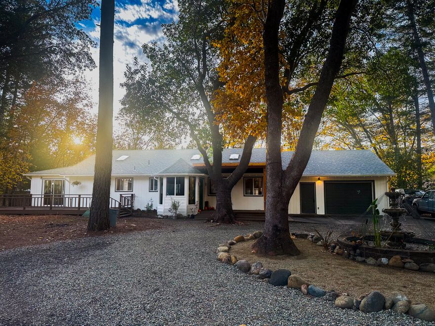 Here's one to share everywhere!  1994 3 bd 2 ba 2,173 sq ft home with attached 2 car garage on 5.31 acres.  Over 5 acres of secluded tranquility- AND this property has something special: a fully automated 40x140 greenhouse. With propane heat, fans and electric blackout curtains. The home has a new HVAC system.  The setting is peaceful and private, off the road with neighbors at a good distance. There's a seasonal creek that meanders through the property, adding to the natural beauty. Electric gate access on a private drive.  Inside, enjoy abundant natural light through six skylights. Two skylights grace the living room, with one illuminating the large kitchen and one in each of the bedrooms.  The back deck is spacious and offers endless possibilities for entertaining guests and enjoying outdoor cooking. 
The trees in the front yard are limbed up, allowing in sunlight while maintaining a forested ambiance. 
(tax assessor's page reads 2 bed) 
Call to schedule a showing today!