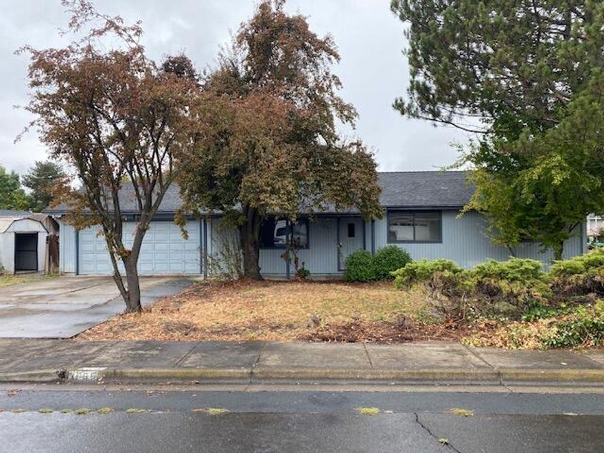 Great location in a quiet East Medford neighborhood and offers a large corner lot.  Offers a fully fenced back yard and storage.  Step inside this 3 bedroom 2 bathroom home that offers a large living room and tons of potential.