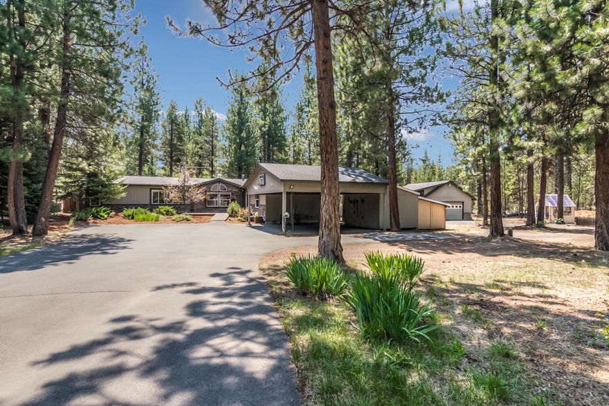 Nestled amongst Ponderosa Pines, this large single level home on a rare 1.13 Acre gives it a private retreat feeling. Full RV hookups w/water, power & dump on a circle driveway. Beautiful low maintenance landscaping surrounds you as you pull into this quiet get-a-way home. There's a large office to work remotely or bonus room. The private back yard offers a huge, covered patio/deck just perfect for entertaining or relaxing with your favorite beverage. The national forest with miles of trails is just at the end of the road. Home is completely ready, even w/a large finished shop for all your toys. Infront of the home is a large covered carport. The home features many upgrades like hardwood floors, granite counter tops, tiled showers, newer appliances, walk in closets, Heat Pump Ready, and plenty of room for all. The cute warm free-standing fireplace will keep you warm and cozy after a long day at the mountain. Just minutes to Sunriver, Mt. Bachelor, Deschutes River and Cascade Lakes